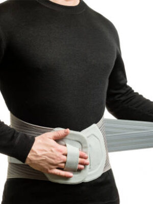 Torso of a man in an orthopedic corset on a white background.