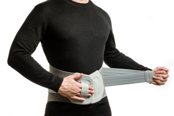 Torso of a man in an orthopedic corset on a white background.