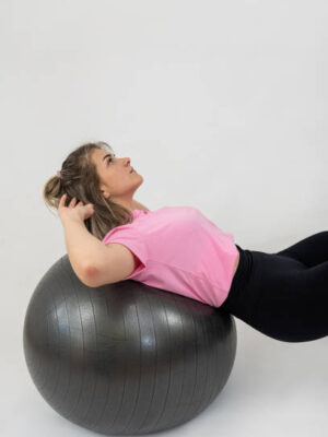 Athletic woman make workout on gym ball on white background. sport concept